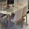 A dining table with chairs in a modern setting. Produktbild-Vorschau