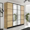 A modern bedroom or living room with a large wardrobe and plants. Voir les images du produit