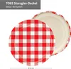 A close-up view of a red and white checkered jar lid, with the inside of the lid visible. Produktbild-Vorschau