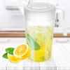 A pitcher of lemonade with lemons and mint leaves on a wooden table. Náhľad obrázku produktu