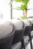 A close-up view of the back of a modular sofa with textured dark gray rope detailing and light gray cushions. Produktbild-Vorschau