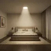 A bedroom with a bed, nightstands, and curtains, illuminated by a ceiling light. Náhľad obrázku produktu