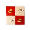 Four square tiles arranged in a 2x2 grid, each displaying a graphic of either a hat or glasses. Produktbild-Vorschau