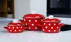Three red and white polka dot pots are displayed on a white countertop in a kitchen setting. Anteprima dell’immagine prodotto