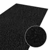 A close-up view of a black shaggy rug. Náhled obrázku produktu