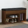 A shoe bench with storage compartments and a cushioned top, displaying various shoes and boots. Náhled obrázku produktu
