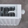 Close-up of a white radiator with a temperature control knob. Produktbild-Vorschau
