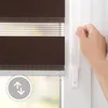 A hand is shown pulling the cord of a brown and white striped roller blind. Produktbild-Vorschau
