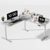 A white L-shaped standing desk with computer monitors, a laptop, and office accessories. Produktbild-Vorschau