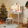 A child's vanity set decorated for Christmas, with a Christmas tree and presents. Produktbild-Vorschau