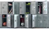 A row of open school lockers filled with sports equipment and other items. Produktbild-Vorschau