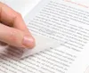 A hand is shown lifting a transparent sticky note from a book page. Produktbild-Vorschau