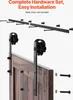 A barn door hardware set is shown, with the track and rollers mounted on a wooden door. Produktbild-Vorschau