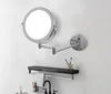 A bathroom vanity area with a wall-mounted LED makeup mirror, a shelf with toiletries, and a faucet. Produktbild-Vorschau