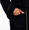 A close-up shot of a person's hand in the pocket of a dark blue robe with gold trim. Podgląd zdjęcia produktu