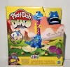 The image shows the packaging of a Play-Doh Dino Crew toy set, featuring a blue dinosaur and various Play-Doh accessories. Produktbild-Vorschau