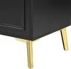 A close-up of the bottom corner of a black sideboard with gold legs. Anteprima dell’immagine prodotto