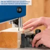 A person is using a blue bandsaw to cut a piece of wood. Produktbild-Vorschau