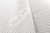 A close-up, abstract shot of a white textured fabric with embossed text. Anteprima dell’immagine prodotto