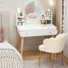 A white vanity table with a round mirror and makeup products, next to a bed and a beige chair. Anteprima dell’immagine prodotto