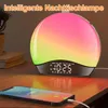 A bedside lamp with a digital clock and a smartphone charging in the foreground. Produktbild-Vorschau