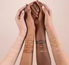 Multiple arms with different skin tones displaying swatches of foundation shades. Produktbild-Vorschau
