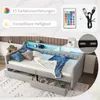 A daybed with LED lighting and USB ports, shown with pillows and blankets, and featuring a remote control and USB cable. Produktbild-Vorschau