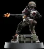 A detailed figurine of a female soldier firing a weapon, posed dynamically on a military-style crate. Náhled obrázku produktu