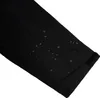 Close-up of a black fabric sleeve with water droplets on it. Produktbild-Vorschau