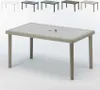 A rectangular outdoor table with a woven rattan-like base and a textured tabletop, shown in a studio setting with a white background. Several other tables in different colors are visible in the background. Anteprima dell’immagine prodotto