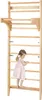 A young child is climbing on a wooden wall-mounted gym. Produktbild-Vorschau