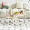 A living room scene with a couch, pillows, a blanket, and two nesting coffee tables. Voir les images du produit