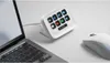 A white Elgato Stream Deck Neo is placed on a white desk next to a laptop and a white computer mouse. Náhled obrázku produktu