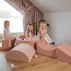 Three young girls playing in a soft play area with foam blocks and a ball pit. Produktbild-Vorschau