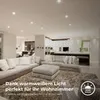 A modern living room with sofas and a rug, illuminated by ceiling lights. Produktbild-Vorschau