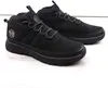 A pair of black mid-top boots on a white surface. Voir les images du produit