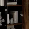 A close-up view of a wooden cabinet with shelves displaying books and decorative items. Produktbild-Vorschau