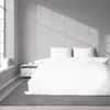 A neatly made bed with white striped bedding in a room with natural light coming through a window. Produktbild-Vorschau