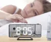 A woman reaching for a digital alarm clock on a bedside table. Náhled obrázku produktu