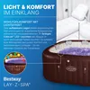 A promotional image for a Bestway Lay-Z-Spa, highlighting its lighting and comfort features with text descriptions and visual cues. Produktbild-Vorschau