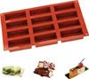 A red silicone mold for baking rectangular items, shown with examples of finished baked goods. Produktbild-Vorschau