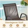 Close-up of a brown mesh chair back with white wavy lines indicating breathability, set against a blurred background of a balcony or deck. Podgląd zdjęcia produktu
