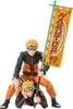 Two Naruto action figures are posed together, one sitting on the other's shoulders, holding a banner. Produktbild-Vorschau