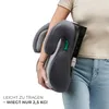 A person is holding a folded car seat booster. The background is white. Náhled obrázku produktu