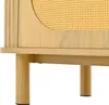 A close-up view of the lower section of a wooden sideboard with rattan detailing. Voir les images du produit