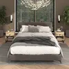 A bedroom scene featuring a bed with nightstands and a chandelier. Produktbild-Vorschau