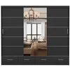A black sliding door wardrobe with mirrored doors and drawers at the bottom, reflecting a bedroom interior. Produktbild-Vorschau