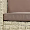 A close-up view of a beige polyrattan lounge chair with brown cushions. Produktbild-Vorschau
