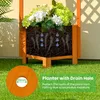 A wooden planter with flowers and roots, showing a drain hole and water droplets. Podgląd zdjęcia produktu