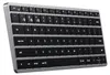 A close-up, angled view of a silver and black wireless keyboard. Náhled obrázku produktu